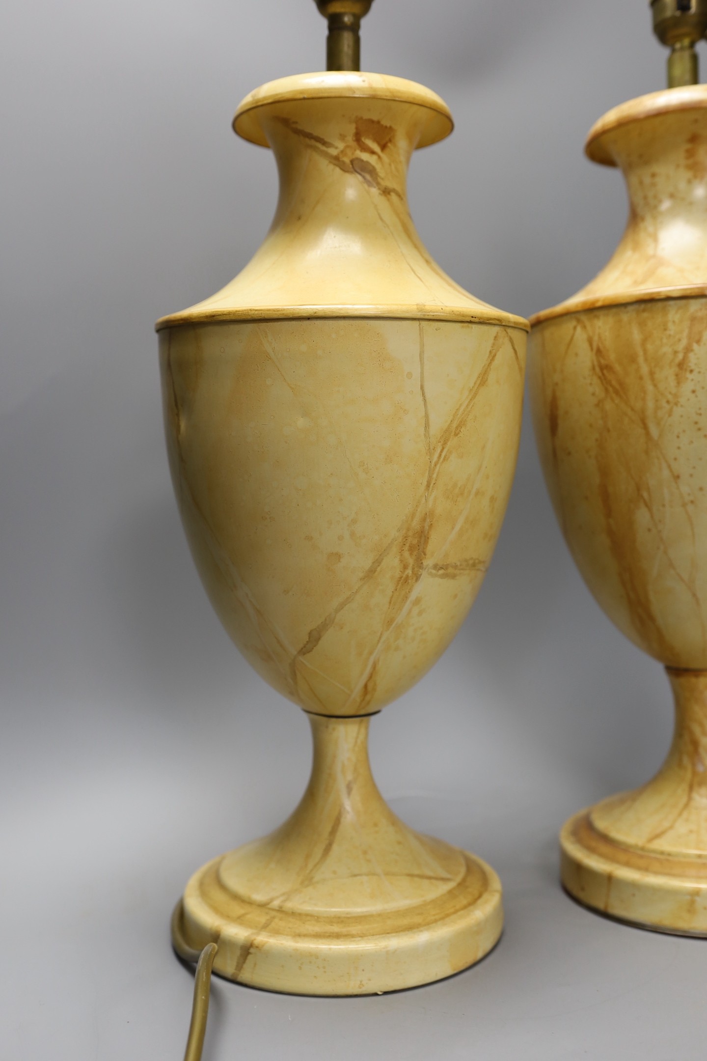 A pair of faux marble toleware style lamps, 41 cms high not including fittings